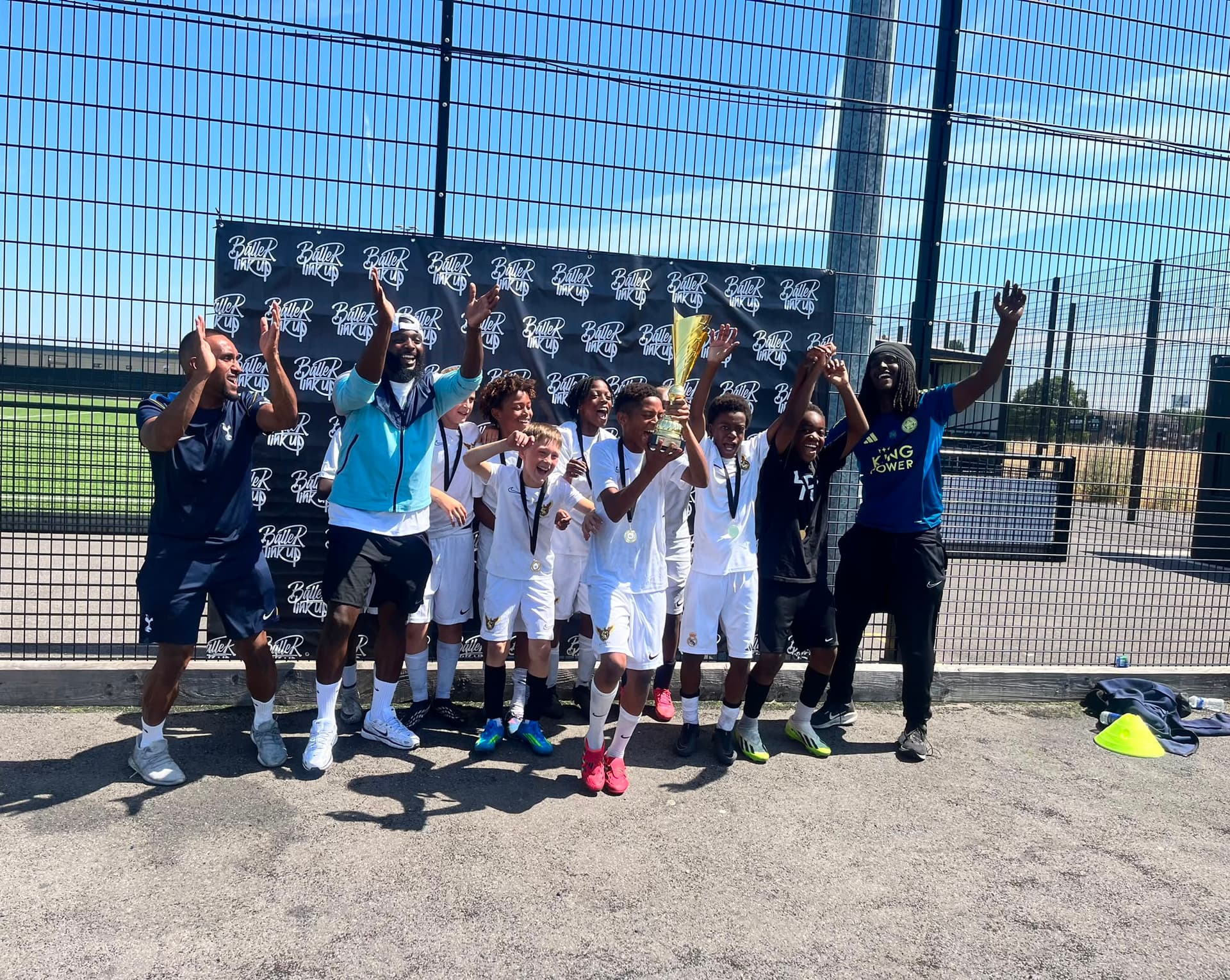 Supreme Showcase U10s lift the trophy — champions