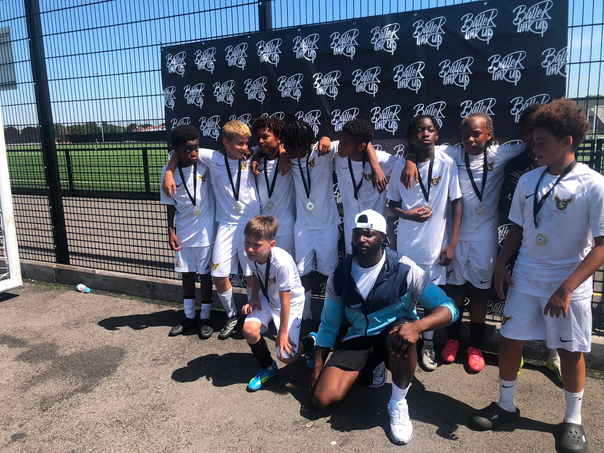 Ballers Link Up — U12s squad with medals